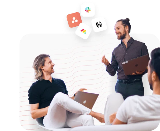 Remote Sensei consultants working through a client's plan on laptops, with Asana, Slack, Notion and Google Workspace icons above them